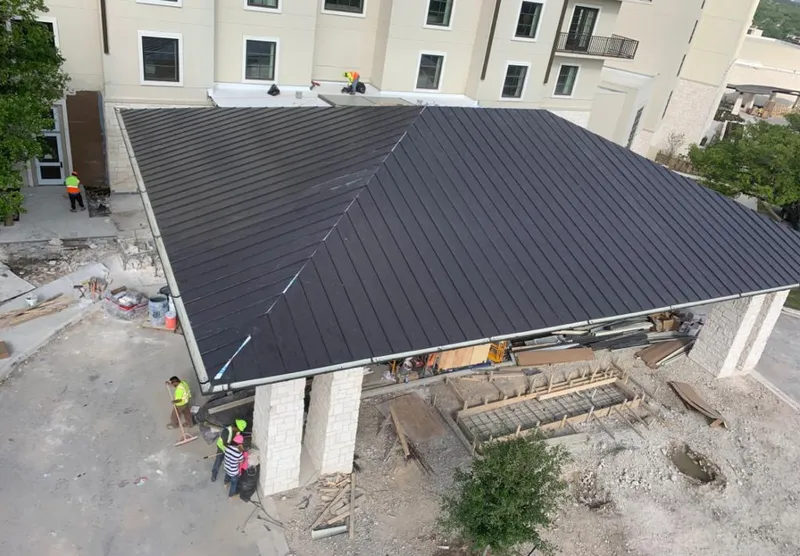 Metal roofing installation team working on a commercial building in Spring Hill